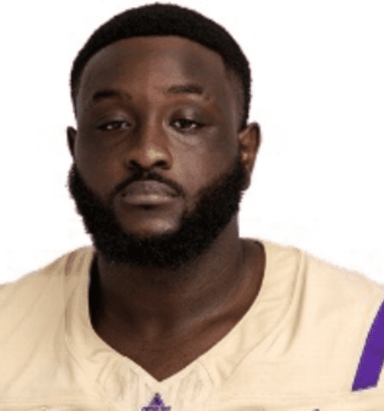 Shardez Taylor in a football uniform, looking serious and confident.