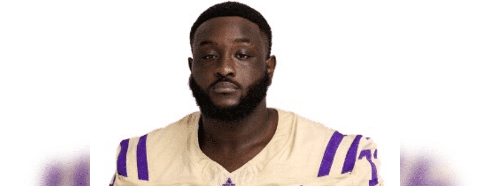 Shardez Taylor in a football uniform, looking serious and confident.