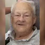 Elderly man with gray hair smiling warmly at the camera. — William