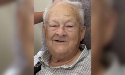Elderly man with gray hair smiling warmly at the camera. — William