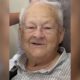 Elderly man with gray hair smiling warmly at the camera. — William