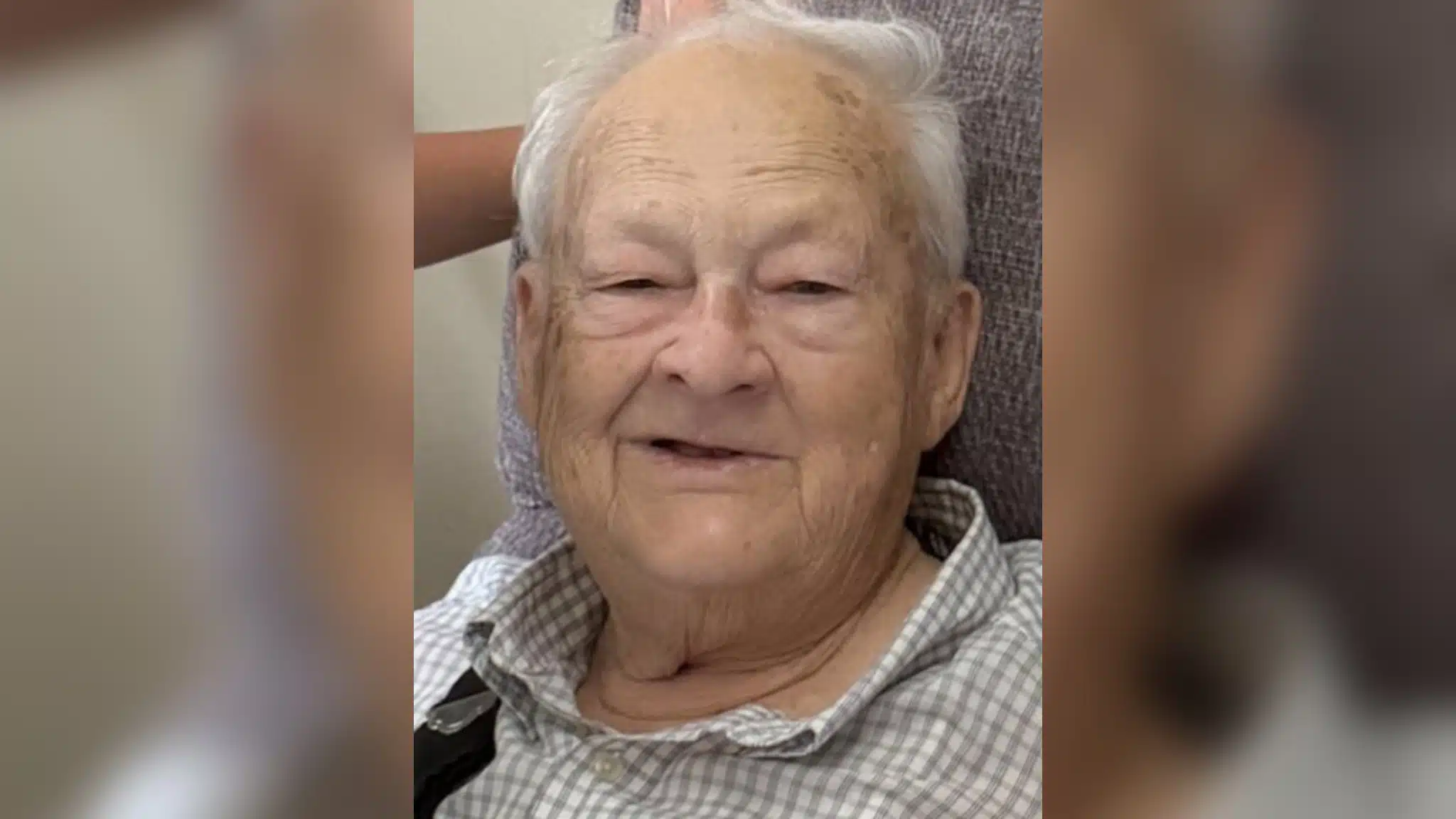 Elderly man with gray hair smiling warmly at the camera. — William