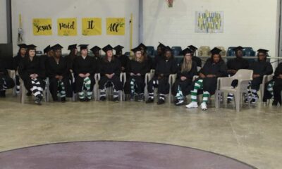 Graduates in caps and gowns sit in a row at — 25 incarcerated women graduate from programs at Delta Correctional Facility