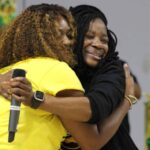 Dana Road Elementary celebrates B rating as two women embrace in — Dana Road Elementary celebrates B rating with students