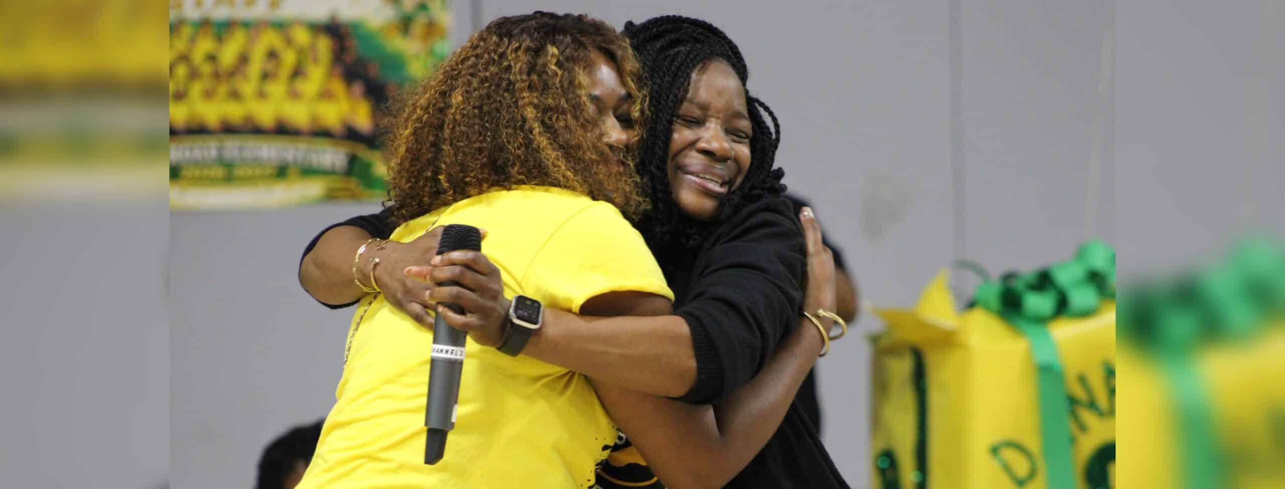 Dana Road Elementary celebrates B rating as two women embrace in — Dana Road Elementary celebrates B rating with students