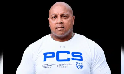 William Prince, a former athlete, wearing a white shirt with PCS logo, looking serious and confident.