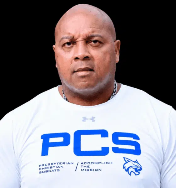 William Prince, a former athlete, wearing a white shirt with PCS logo, looking serious and confident.