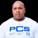 William Prince, a former athlete, wearing a white shirt with PCS logo, looking serious and confident.