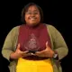 Patrice Johnson proudly holds her Mississippi Middle School Teacher of the Year award, smiling in a professional setting.