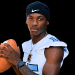 A football player in a blue and white jersey poses confidently with a football — Port Gibson defeats Franklin County 30-21