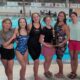 Warren Central girls swim team celebrating their North State championship win at De — Warren Central wins North State swim