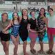 Warren Central girls swim team celebrating their North State championship win at De — Warren Central wins North State swim