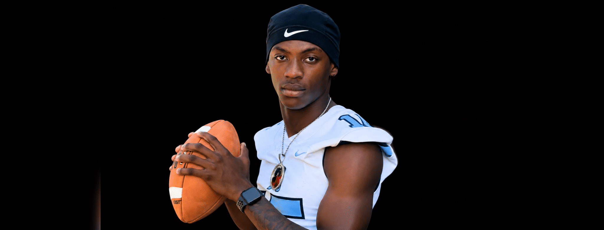 A football player in a blue and white jersey poses confidently with a football — Port Gibson defeats Franklin County 30-21