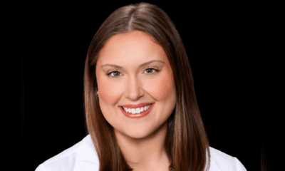 Portrait of a smiling woman with long brown hair, wearing a white coat. — Madeleine Gaul