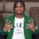 Wallyss Curry, a Vicksburg High School linebacker, shows four fingers while wearing a green an — Wallyss Curry 100 tackles