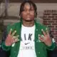 Wallyss Curry, a Vicksburg High School linebacker, shows four fingers while wearing a green an — Wallyss Curry 100 tackles