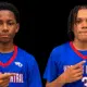 Gayvin Turner and Mason Truly in blue Warren Central basketball jerseys, pointing toward their uniforms.