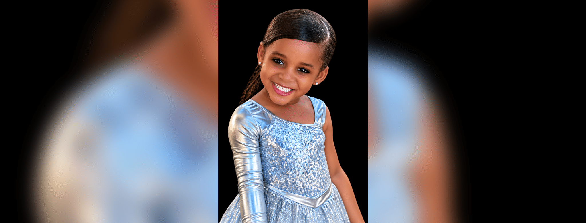 Portrait of Paris Morris Jones smiling in a light blue, sparkling dress