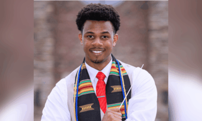 Kameren Batty smiles in a white shirt, red tie and colorful stole.