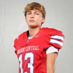 Warren Central High School kicker Nick Lee in a red football uniform, posing confidently against a plain background.