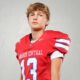 Warren Central High School kicker Nick Lee in a red football uniform, posing confidently against a plain background.
