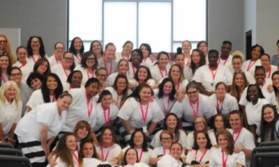 Group photo of 39 women inmates in white shirts celebrating graduation from a rehabilitation program.
