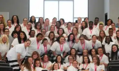 Group photo of 39 women inmates in white shirts celebrating graduation from a rehabilitation program.