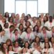 Group photo of 39 women inmates in white shirts celebrating graduation from a rehabilitation program.