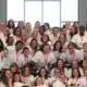 Group photo of 39 women inmates in white shirts celebrating graduation from a rehabilitation program.