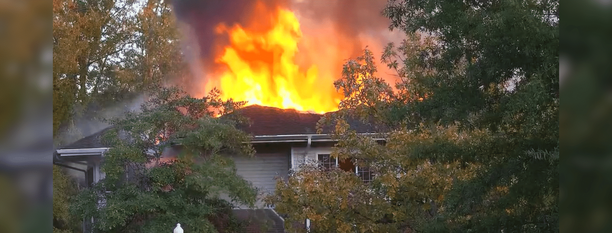 Flames and smoke rise from the roof of an assisted — Two Vicksburg natives killed in Clinton assisted living facility fire