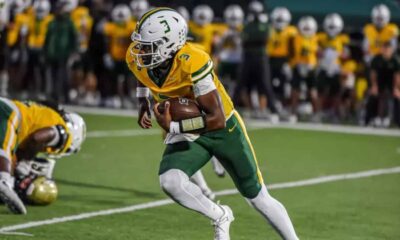 Belhaven football player running with the ball during a game against NC Wesleyan.