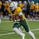 Belhaven football player running with the ball during a game against NC Wesleyan.