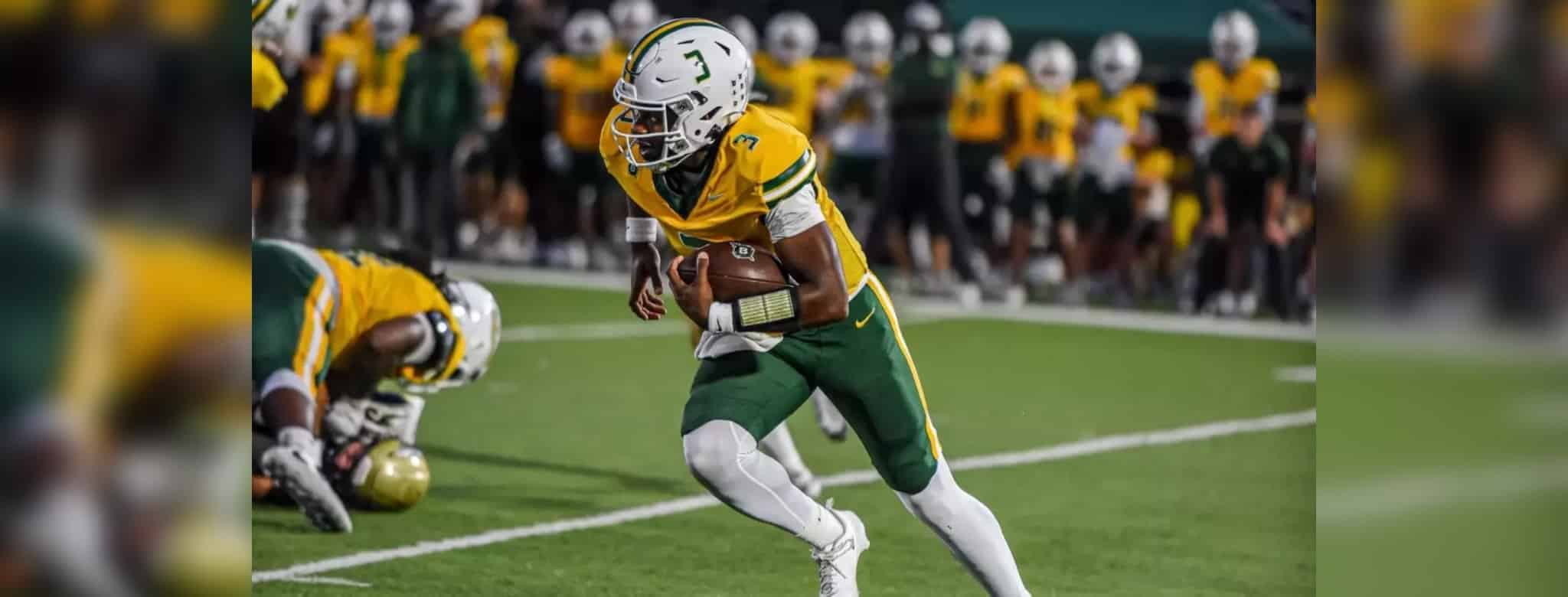 Belhaven football player running with the ball during a game against NC Wesleyan.