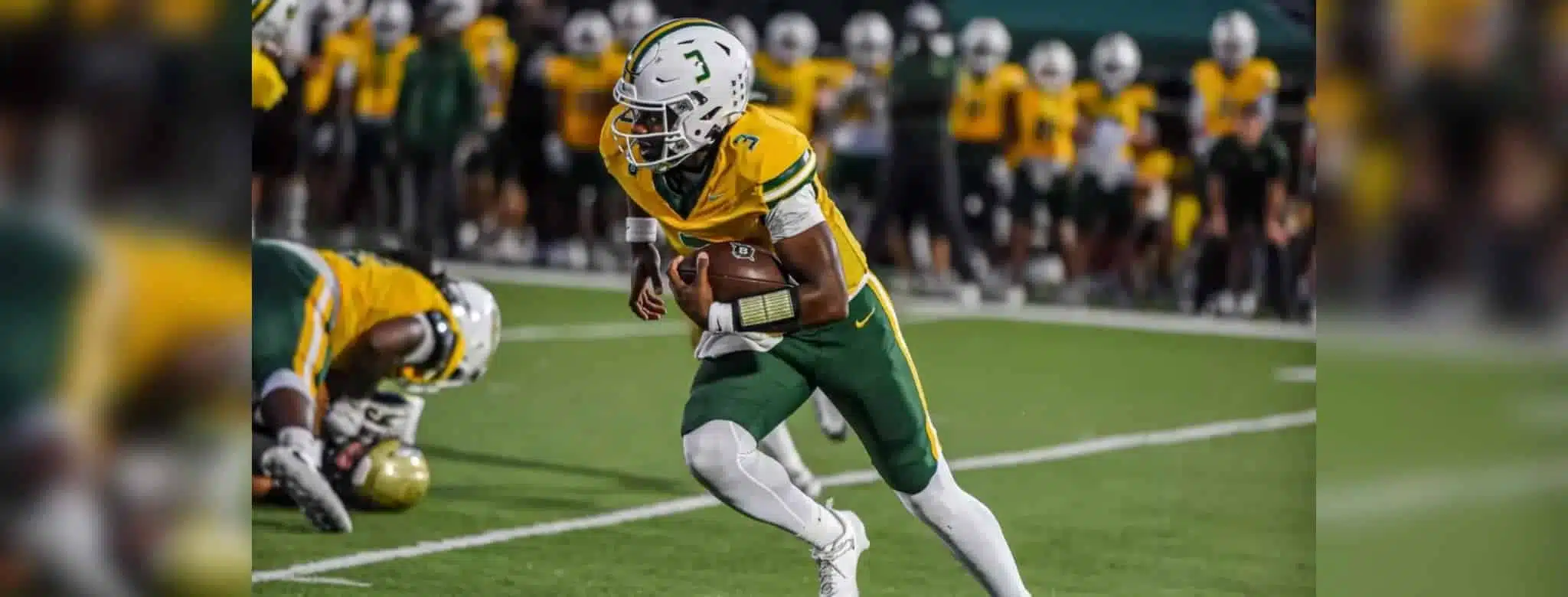 Belhaven football player running with the ball during a game against NC Wesleyan.