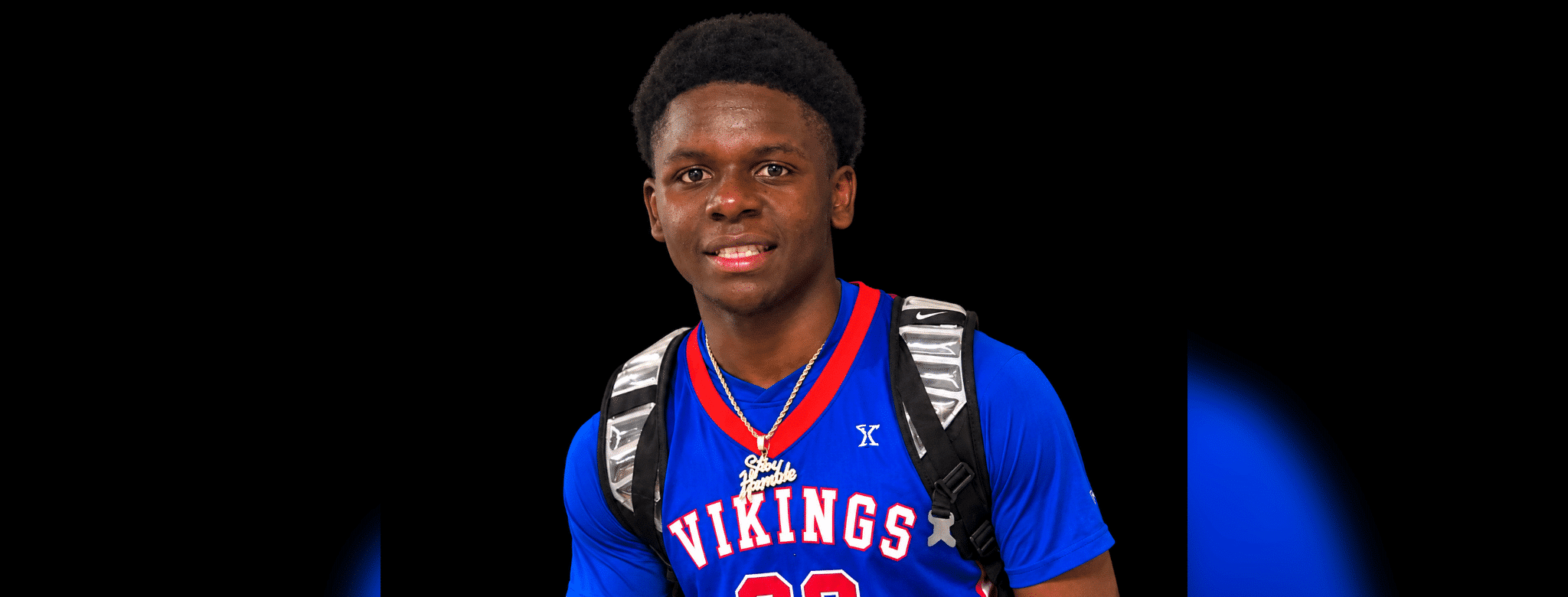 WC freshmen Ridgeland player in a blue Vikings basketball jersey with a backpack against a black background.