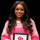 Jayla Hicks smiles while holding a Clinton High School award plaque. — Jayla Hicks earns All-District volleyball honors