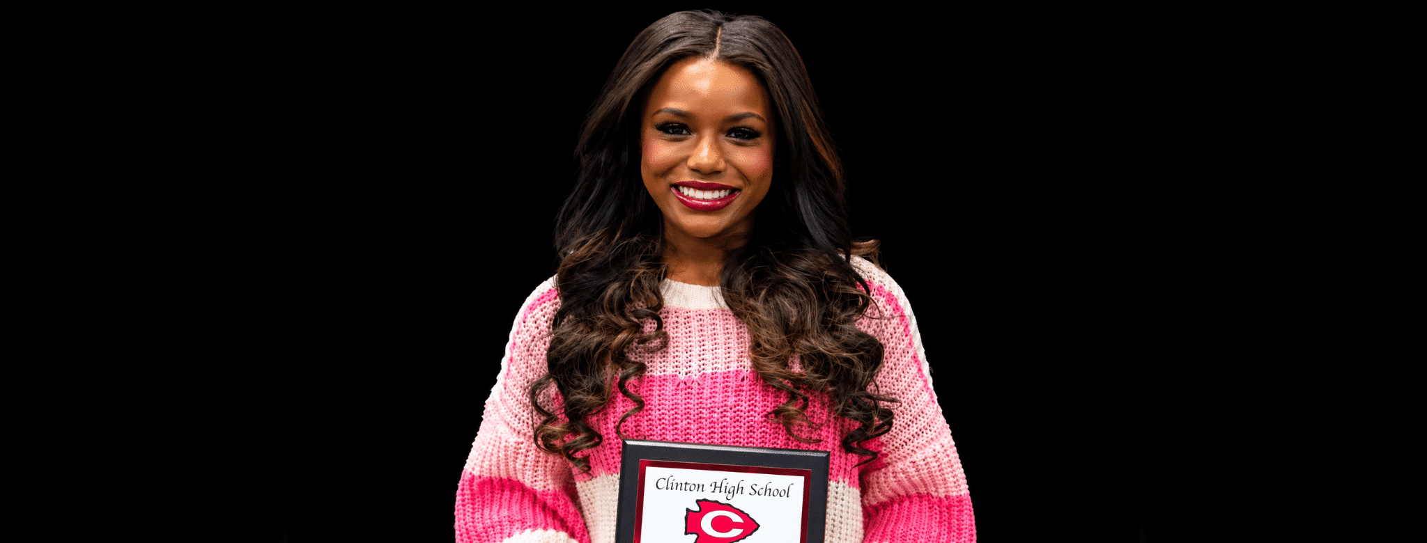 Jayla Hicks smiles while holding a Clinton High School award plaque. — Jayla Hicks earns All-District volleyball honors