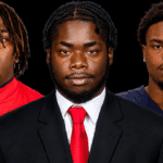 Three defensive linemen from Vicksburg in formal attire, showcasing their athleticism and teamwork.