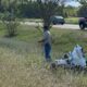 A Warren County Sheriff’s deputy injured in motorcycle crash, with responders and debris visible in the background.