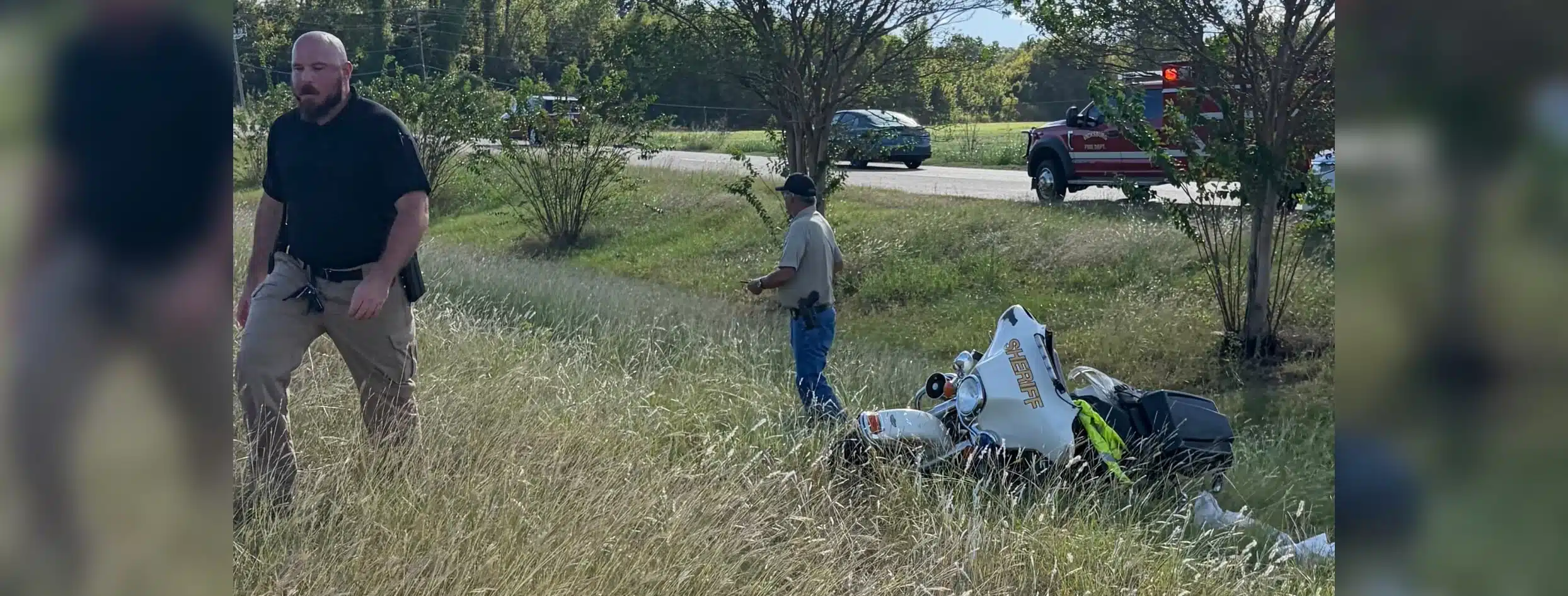 A Warren County Sheriff’s deputy injured in motorcycle crash, with responders and debris visible in the background.