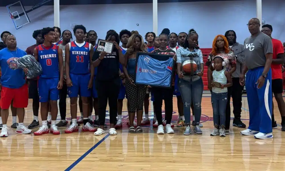 Warren Central High School basketball team and family memb — Warren Central honors the life and legacy of Henry Trisby III