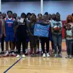 Warren Central High School basketball team and family memb — Warren Central honors the life and legacy of Henry Trisby III
