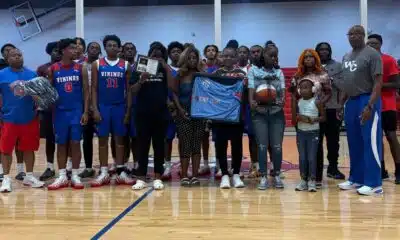 Warren Central High School basketball team and family memb — Warren Central honors the life and legacy of Henry Trisby III