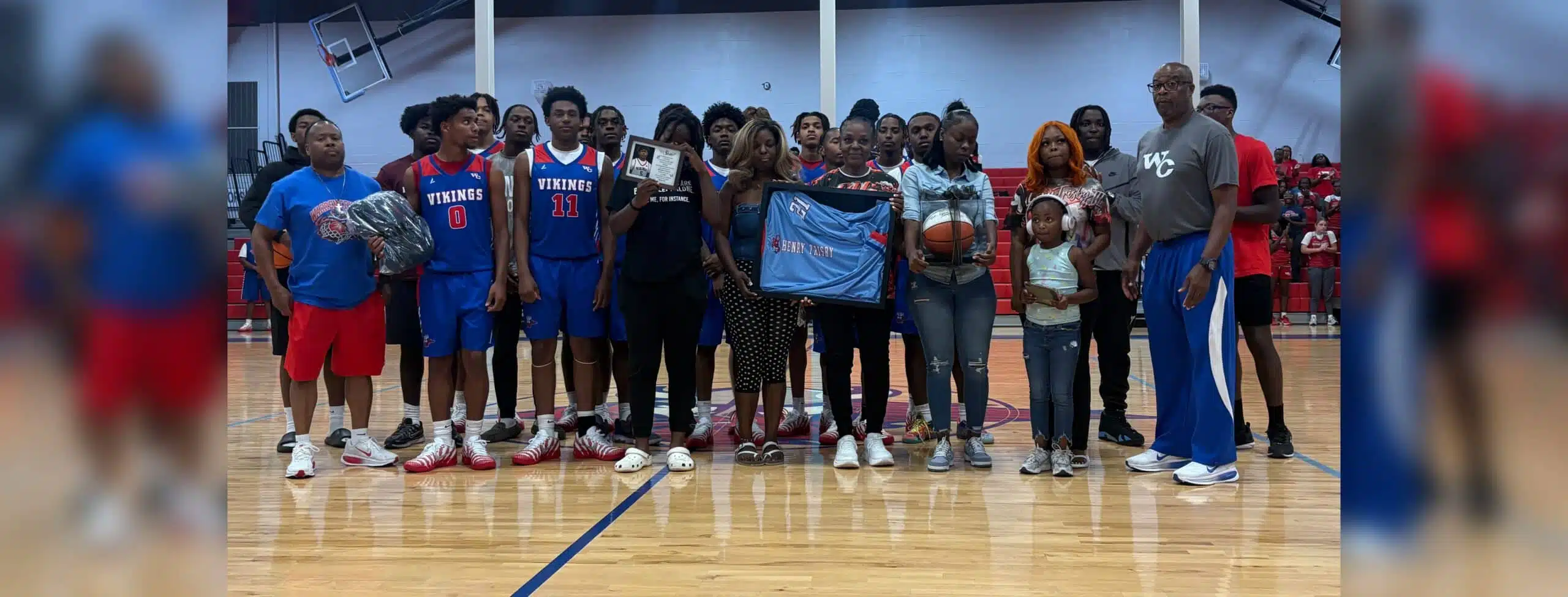 Warren Central High School basketball team and family memb — Warren Central honors the life and legacy of Henry Trisby III