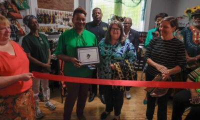 A group of people at a ribbon-cutting ceremony for Sojoz Treasures in Vicksburg.