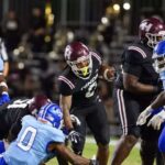 Hinds Community College football players in action during a game against Co-Lin, showcasing a tackle and team effo — 38-13