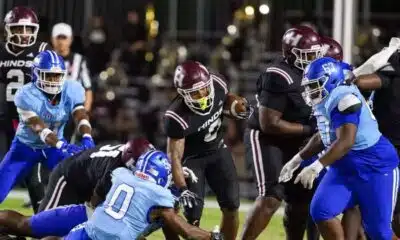 Hinds Community College football players in action during a game against Co-Lin, showcasing a tackle and team effo — 38-13