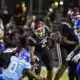 Hinds Community College football players in action during a game against Co-Lin, showcasing a tackle and team effo — 38-13