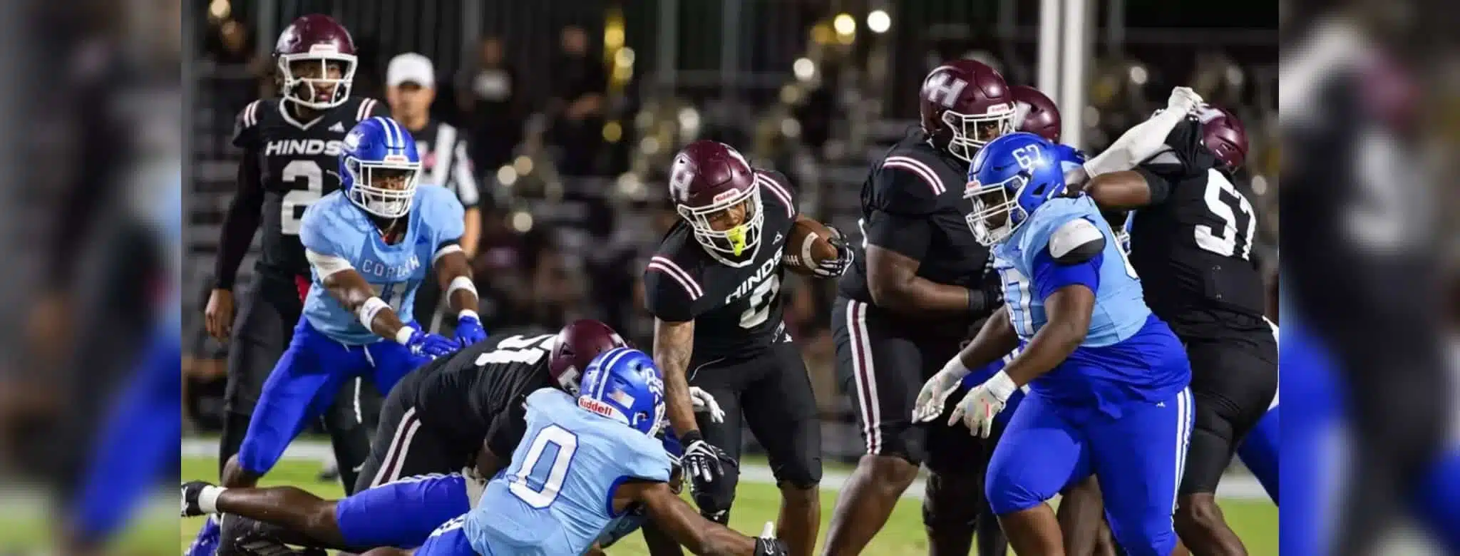 Hinds Community College football players in action during a game against Co-Lin, showcasing a tackle and team effo — 38-13
