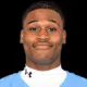 Royale Shelvy, a football player, smiles confidently in his team uniform.